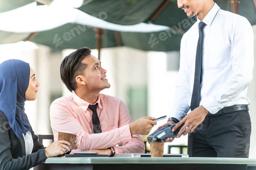 Preview: Waiter Interacting With Muslim Customers Using Bank Terminal To Process And Acquire Mobile Payment