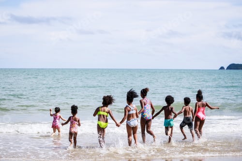 Preview: African American, Kids Group In Swimwear Enjoying Running To Play The Waves On Beach. Ethnically