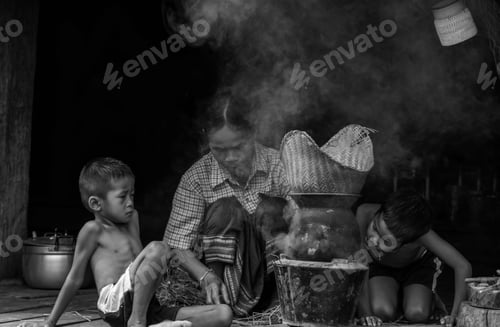 Preview: Lifestyle Of Asian Women In The Field Countryside Thailand.Woman And Son Is Blowing The Fireplace