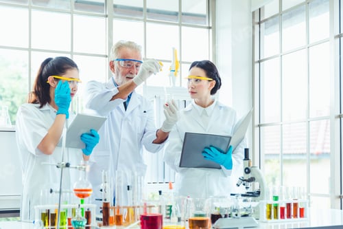 Preview: Science Teacher And Students Team Working With Chemicals In Lab