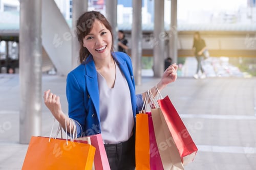 Preview: Asian Woman Shopping Smile And Holding Shopping Bag With Shopping Mall Background, Consumerism