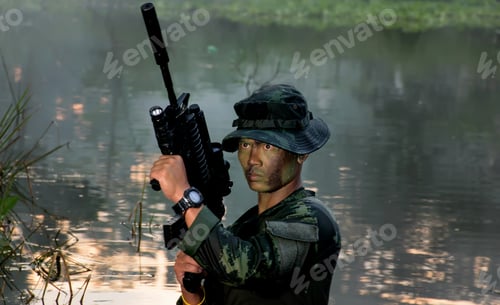 Preview: Soldier With A Rifle.Army Soldier In Protective Uniform Holding Rifle And Standing In Water