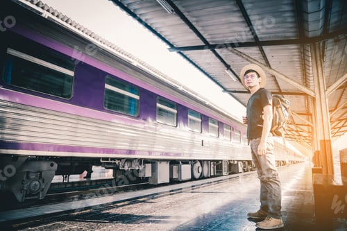 Preview: Travelers, Asian Male Backpackers With Cameras Standing At The Train Station And Waiting For