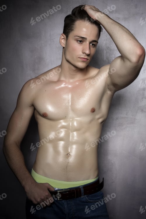 Preview: Sexy Shirtless Male Model Flirting Against Of Grunge Wall.