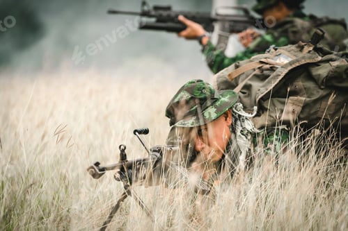 Preview: Soldier Lying On The Ground And Camouflage In Grass. Soldier Holding Gun Weapon And Waring Armor