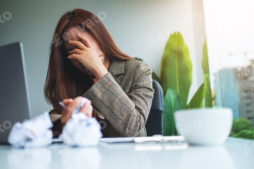 Preview: Businesswoman Get Stressed With Screwed Up Papers And Laptop On Table While Having A Problem At