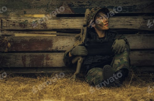 Preview: Woman Soldier.Army Girl With Rifle Sitting In The Forest At Battlefield Area.