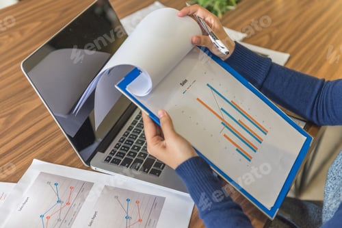 Preview: Sales Manager Checking Sales Reports In Office