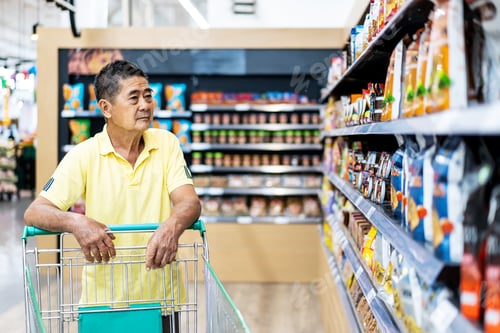 Preview: Asian Senior Man Shopping Trolley Choosing Other Products In Supermarket