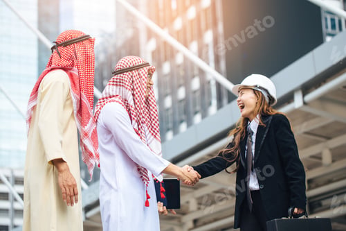 Preview: Business Success Concept. Asian Muslim Businessman And Engineer Woman Making Handshake Or Holding