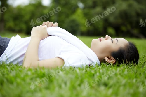 Preview: Fitness Asian Woman Relax Sleep On Grass With The Towel