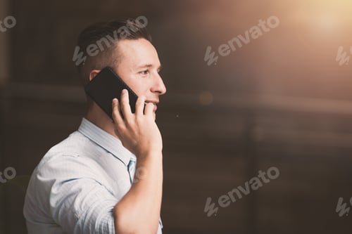 Preview: Outdoor Young Businessman Worker Talking On Smartphone. Business Concept
