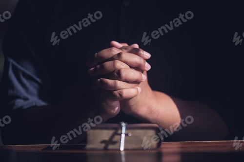 Preview: Christian Man Holding Hands And Praying With Bible,Pleading To God, Christian And Prayer Concept.