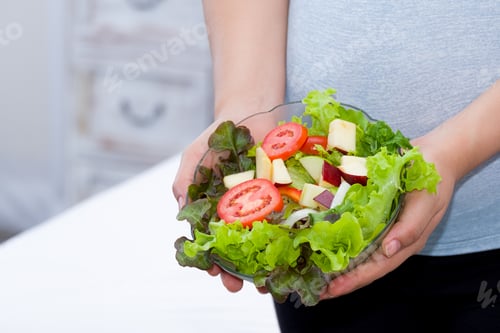 Preview: Woman Is Holding Fruits And Vegetables Salad Bowl. Close Up.