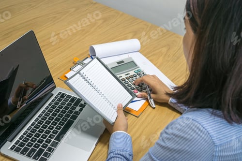 Preview: Asian Office Woman Calculate Financial Number On Document