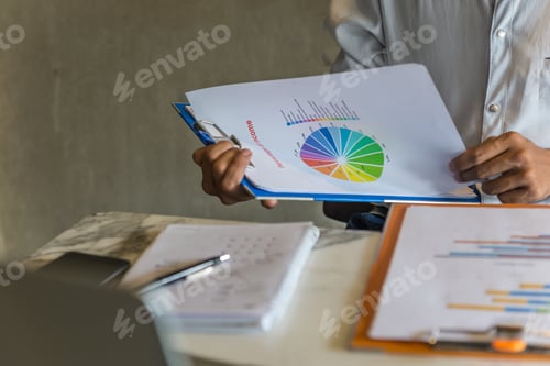 Preview: Businessman Reading The Income Rate On Report