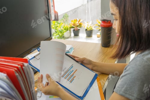 Preview: Businesswoman Reading Financial Document In The Office