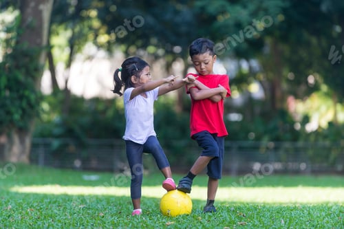 Preview: Siblings - Malay Boy And Girl - Pose With Football At A Park. South East Asian, Muslim Children