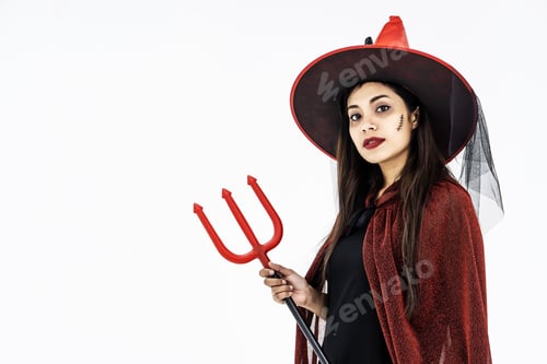 Preview: Happy Halloween Witch With Bright Make-Up And Long Hair Holding Weapon. Isolated On White Background