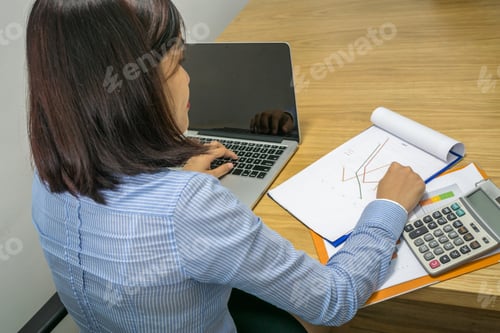 Preview: Female Manager Reading Financial Report In The Office