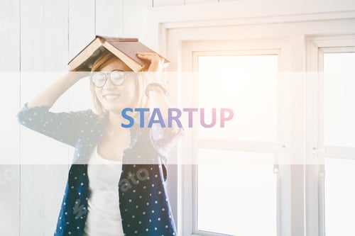 Preview: Startup ? Text With Beautiful Hipster Woman Holding Book On Head And Stylish Glasses In Living