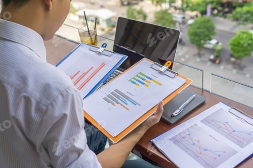 Preview: Young Freelancer Reading Financial Report Outdoor The Balcony