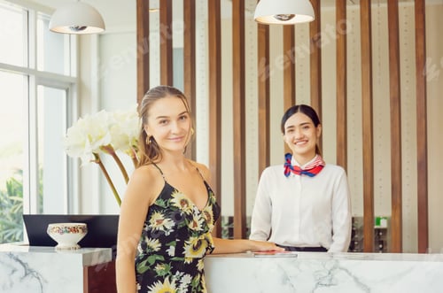 Preview: Happy Guest And Receptionist At Hotel Reception, Young Travellers Standing At Reception Desk With
