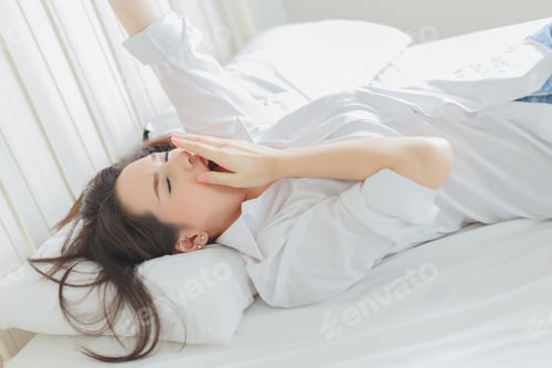 Preview: Beautiful Young Woman Waking Up On The Bed.