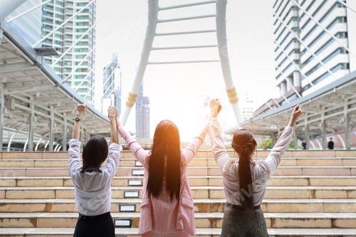 Preview: Rear View Young Asian Businesswoman Group In Formal Wear, They Raising Hands Showing Success Symbol