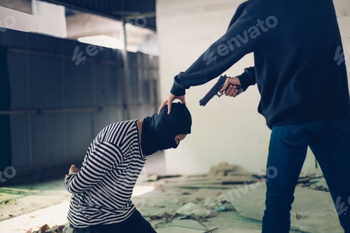 Preview: A Terrorist Man In Hood Holding Gun Kidnapping Young Man For A Hostage In Abandoned Building.