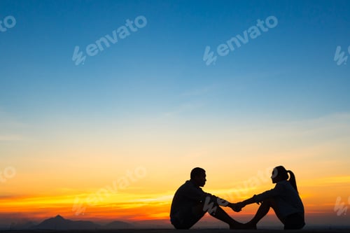 Preview: Young Couple Sitting In The Roof Enjoying And A Beautiful Sunset,Silhouette.