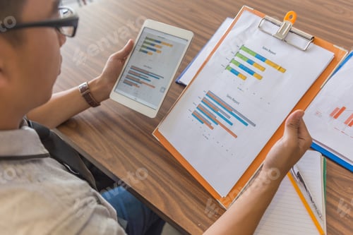 Preview: Office Man Reading Information On Tablet And Document