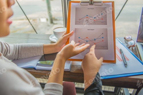 Preview: Close Up Of Women Hands Pointing At Graph Sales Report Data