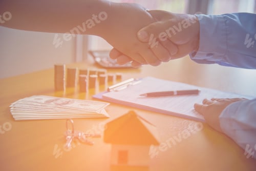 Preview: Estate Agent Shaking Hands With Customer After Contract Signature