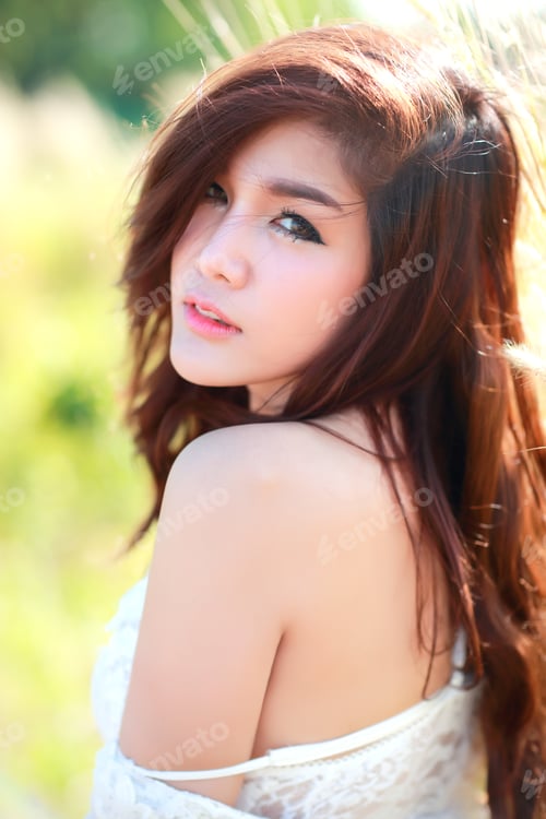 Vista previa: Portrait Of Beautiful Woman Having A Happy Time And Enjoying Among Grass Field In Nature With Sun