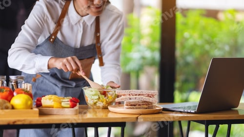 Preview: A Woman Videoblogger Cooking In The Kitchen And Filming, Online Learning Cooking Class Concept