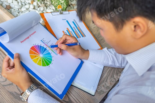 Preview: Asian Financial Executive Analyzing Data In Pie Chart Document
