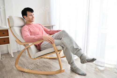 Preview: Portrait Of Young Man Indoors With Very Handsome Face In Pink Casual Shirt On Bedroom