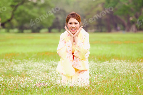 Preview: Asian Young Girl Wearing A Kimono In Natural Green Grass.