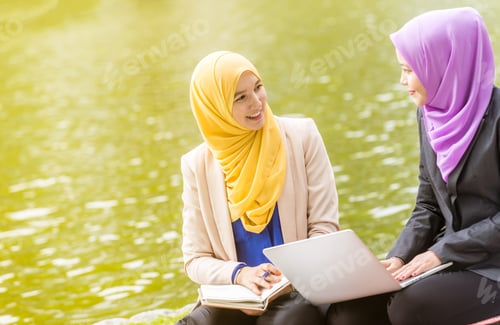 Preview: Muslim Businesswomen/Entrepreneurs Discussing In Front Of A Laptop.