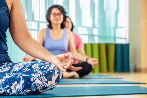 Preview: Time For Yoga. Attractive Young Woman Exercising And Sitting In Yoga Half Lotus Pose With Mudra