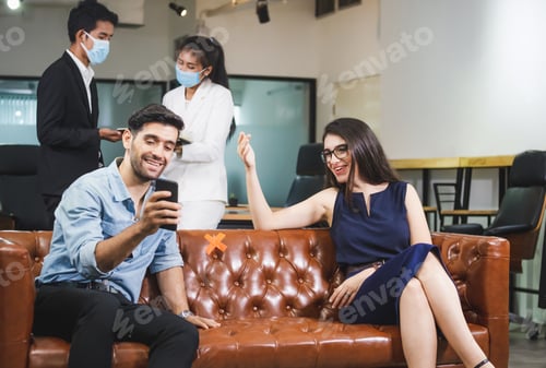 Preview: New Normal Concept, Man And Women Sitting Relaxing, Coworkers Wearing Protection Face Mask Against