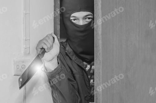 Preview: Stranger Or Robber With Knife In The Room. Someone Holding A Knife In The Shadows Behind A Door.Be