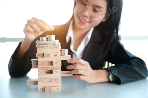 Preview: Businesswoman Playing Wooden Block Game With Money And Coin, Idea Of Management Strategy Concept