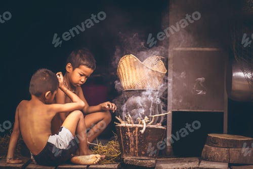 Preview: Lifestyle Of Asian Boy In The Field Countryside Thailand.Two Boy Is Blowing The Fireplace For