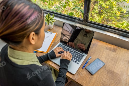 Preview: High Angle View Of Asian Woman Typing Laptop Keyboard