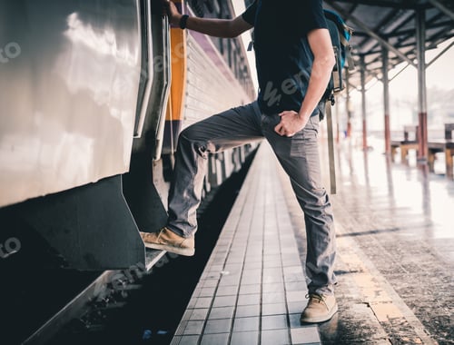 Preview: An Asian Man, A Backpack And A Hat At The Train Station With Travelers. Tourism Concept