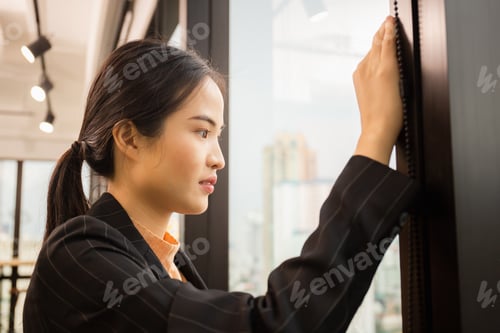 Preview: Woman Standing Near Window Looking Out The Window From A High Floor