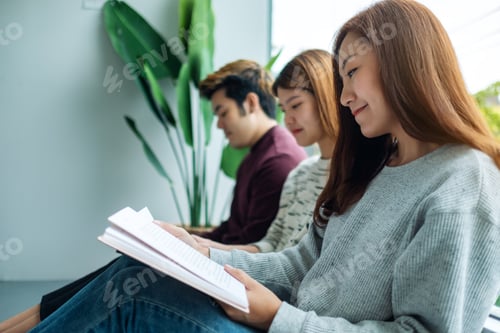 Preview: Group Of Young People Sitting And Enjoyed Reading Books Together