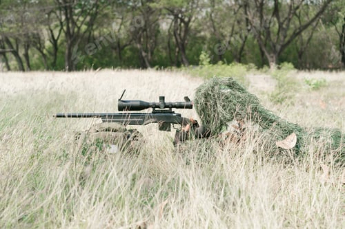 Preview: Sniper Soldier Lying On The Ground And Camouflage In Grass. Soldier Holding Gun Weapon And Waring